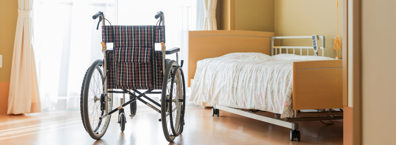 Empty wheelchair and empty bed because of nursing home abuse.